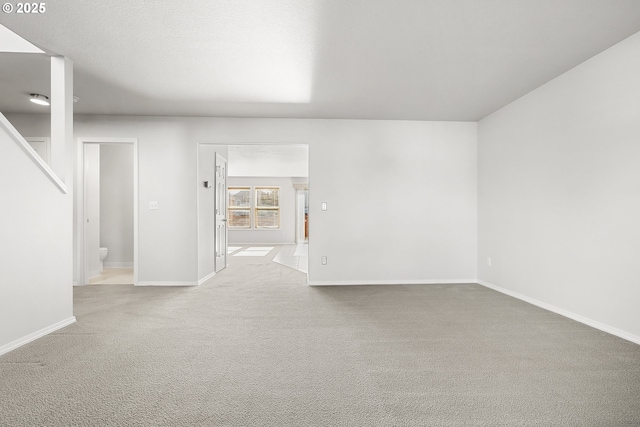 empty room with light carpet and baseboards