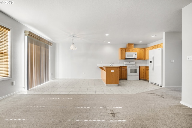 kitchen with decorative light fixtures, light tile patterned floors, recessed lighting, light countertops, and white appliances