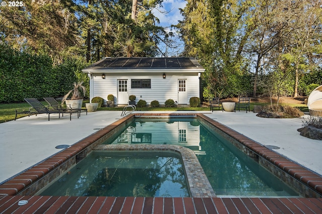 view of swimming pool with an outdoor structure and a patio