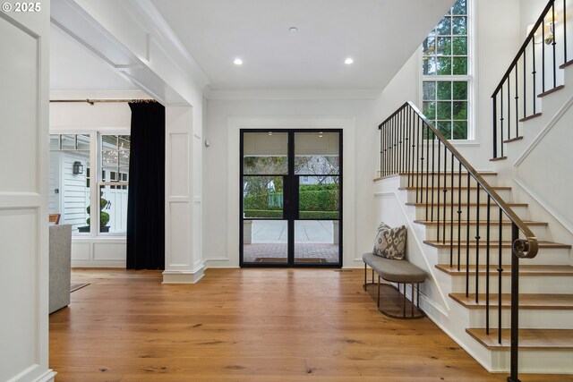 doorway featuring stairs, recessed lighting, ornamental molding, and wood finished floors