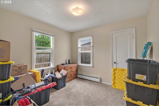 playroom with a baseboard radiator, carpet floors, a textured ceiling, and baseboards