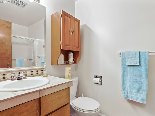 full bathroom with visible vents, decorative backsplash, toilet, a stall shower, and vanity