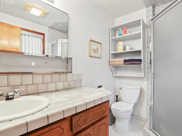 bathroom featuring a stall shower, vanity, and toilet