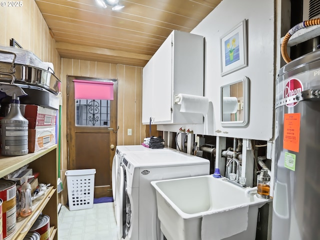 laundry room with cabinet space, wood ceiling, secured water heater, independent washer and dryer, and a sink