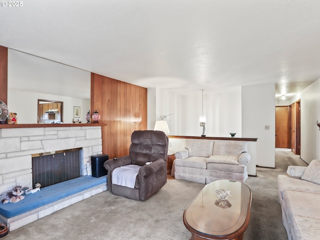 carpeted living area featuring a stone fireplace