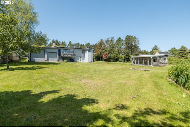 90431 Lewis Rd, Warrenton, OR 97146 - view of grassy yard featuring a garage