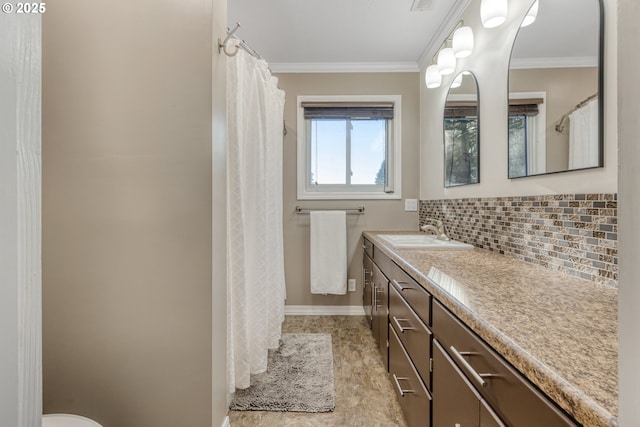 bathroom with decorative backsplash, vanity, and crown molding