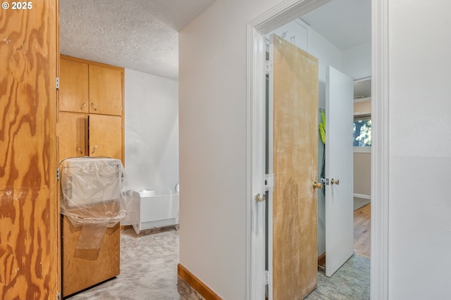 corridor with a textured ceiling