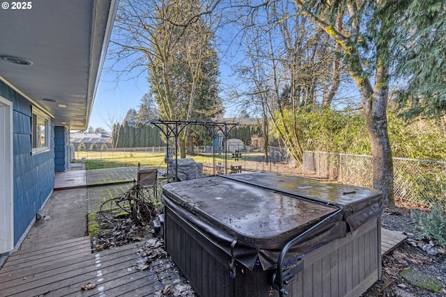 wooden deck featuring a hot tub