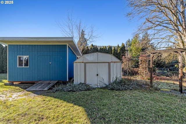 view of outdoor structure featuring a lawn