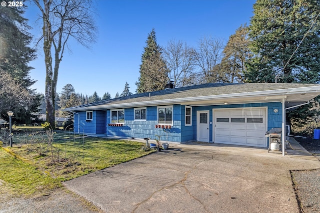 ranch-style home featuring a garage and a front lawn