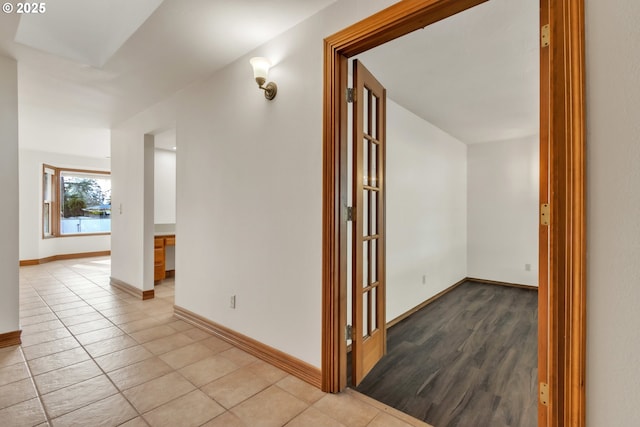 corridor featuring light tile patterned floors