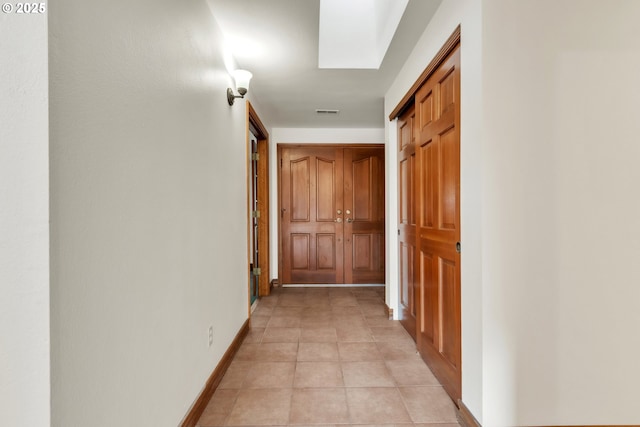 hallway with light tile patterned floors