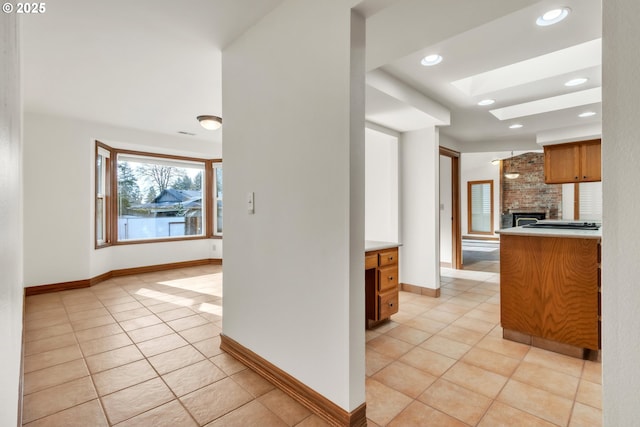 kitchen featuring light tile patterned floors and a fireplace