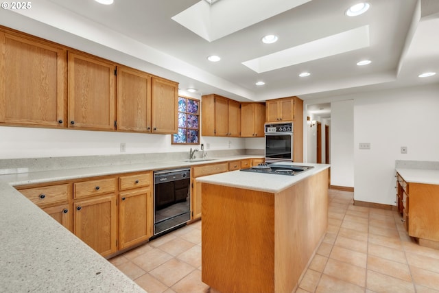 kitchen featuring a skylight, black appliances, a center island, and light tile patterned flooring