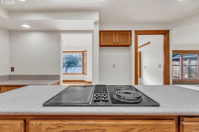 kitchen with light stone counters and black electric stovetop