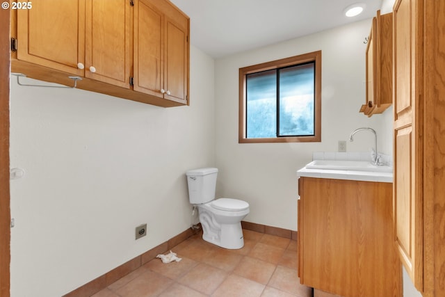 bathroom with tile patterned floors, vanity, and toilet