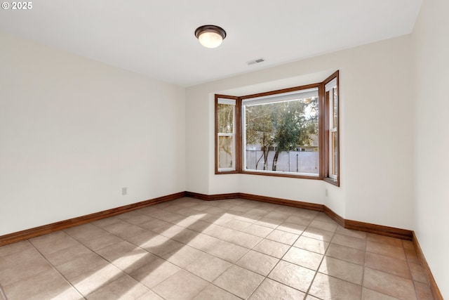 spare room featuring light tile patterned flooring