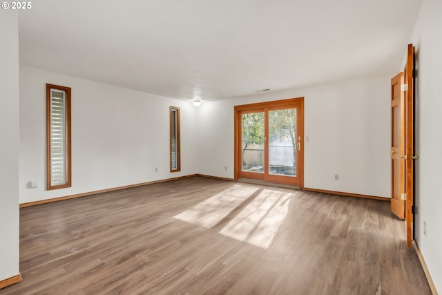 empty room with hardwood / wood-style flooring