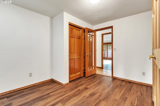 unfurnished bedroom with light wood-type flooring and a closet