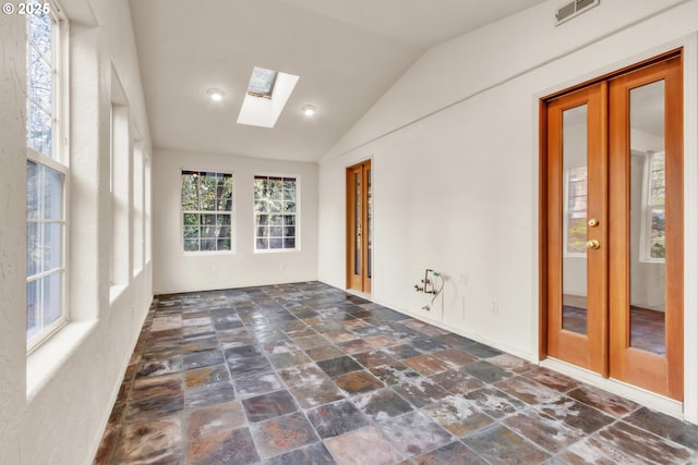 unfurnished sunroom featuring lofted ceiling with skylight and french doors