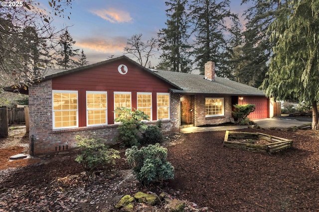 back house at dusk with a garage