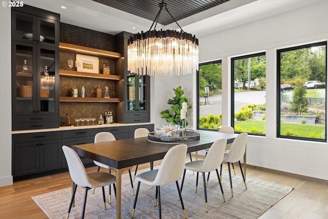 14410 Uplands Dr, Lake Oswego, OR 97034 - dining space featuring a chandelier, a raised ceiling, baseboards, light wood finished floors, and recessed lighting