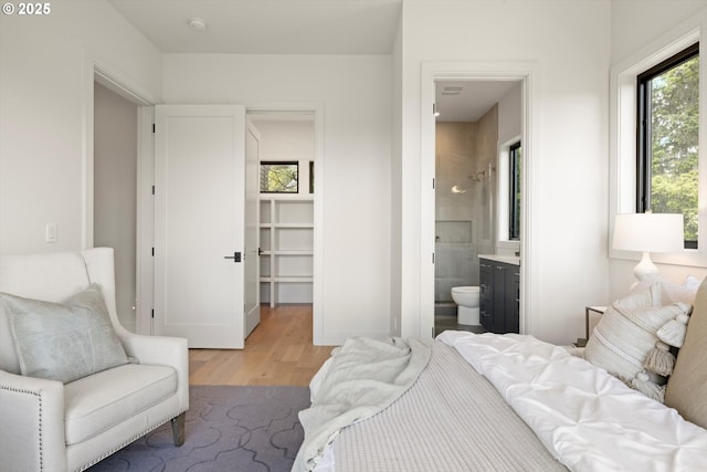 14410 Uplands Dr, Lake Oswego, OR 97034 - bedroom with light wood-style floors, multiple windows, and ensuite bathroom