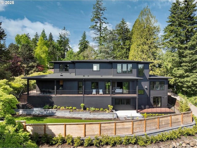 14410 Uplands Dr, Lake Oswego, OR 97034 - back of house featuring stairway, a balcony, and view of wooded area