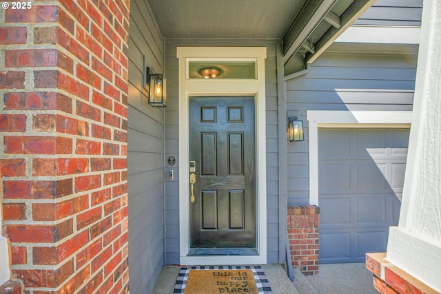 doorway to property with a garage and covered porch