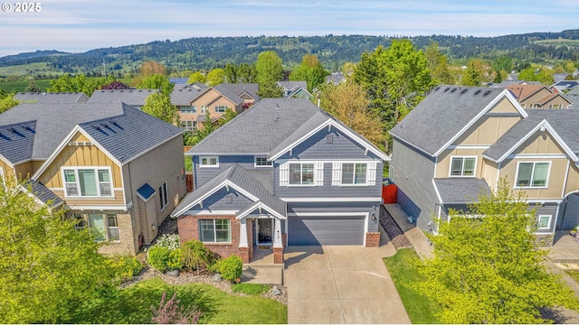 view of front of house with brick siding, an attached garage, driveway, and a residential view