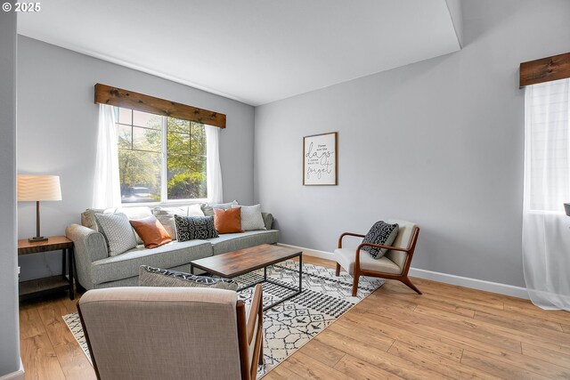 living area with light wood-style floors and baseboards