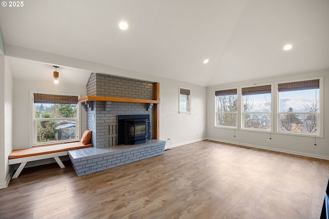 unfurnished living room featuring recessed lighting, wood finished floors, baseboards, and vaulted ceiling