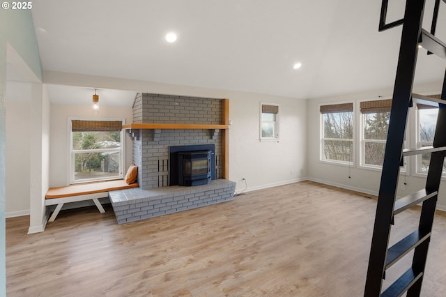 unfurnished living room featuring baseboards, lofted ceiling, and wood finished floors