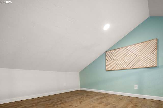 bonus room with lofted ceiling, wood finished floors, and baseboards