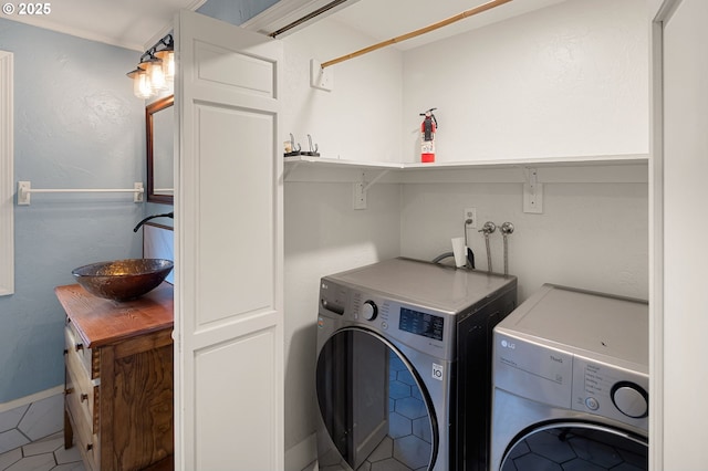 laundry area featuring washing machine and clothes dryer, laundry area, and a sink