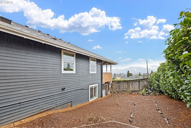 view of side of home featuring fence