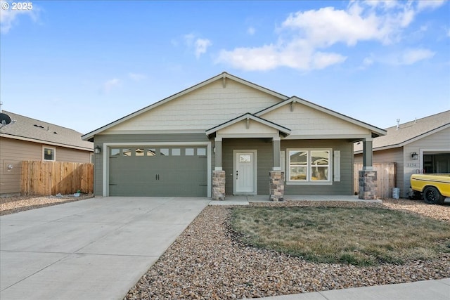 view of front facade featuring a garage, concrete driveway, and fence