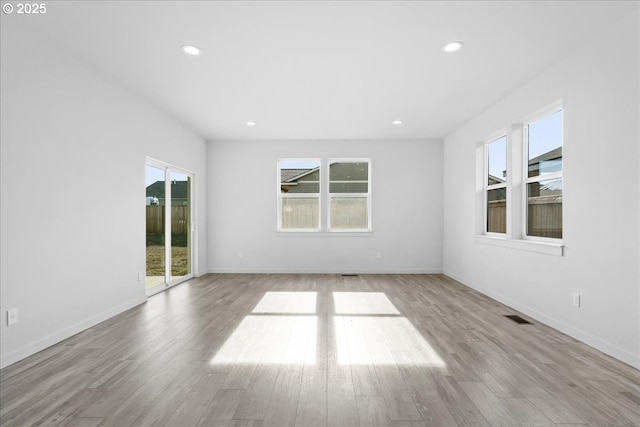 spare room with recessed lighting, visible vents, and wood finished floors