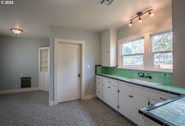 351 Juniper St, Junction City, OR 97448 - kitchen featuring heating unit, tile counters, white cabinetry, visible vents, and backsplash