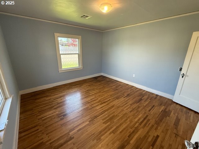 351 Juniper St, Junction City, OR 97448 - unfurnished room with visible vents, wood finished floors, baseboards, and ornamental molding