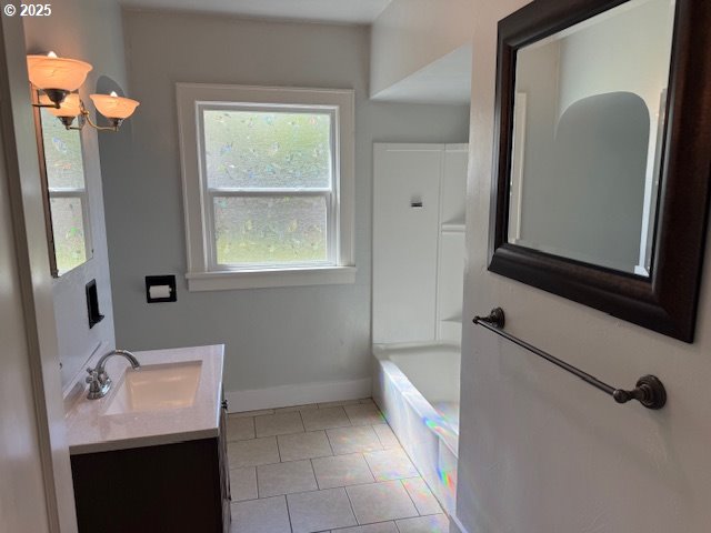 351 Juniper St, Junction City, OR 97448 - bathroom featuring tile patterned floors, baseboards, vanity, and a bath