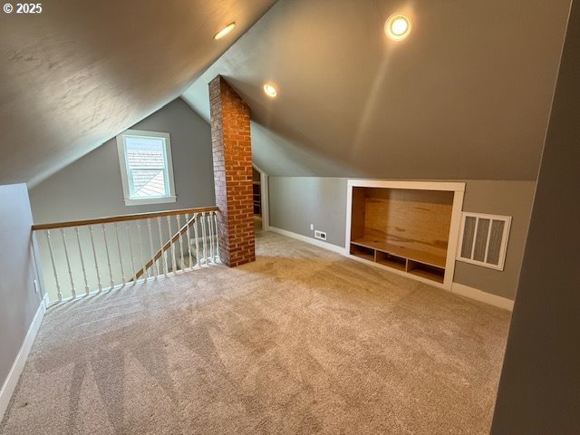 351 Juniper St, Junction City, OR 97448 - bonus room with lofted ceiling, carpet flooring, visible vents, and baseboards