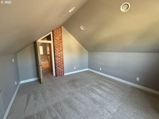 351 Juniper St, Junction City, OR 97448 - additional living space featuring carpet, vaulted ceiling, and baseboards