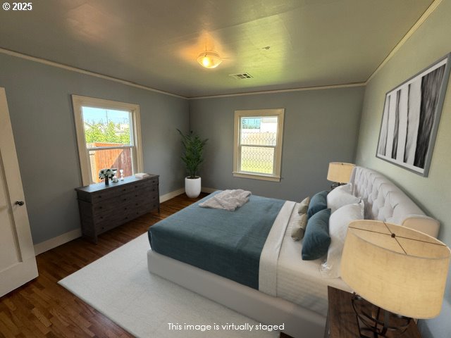 351 Juniper St, Junction City, OR 97448 - bedroom featuring baseboards, multiple windows, visible vents, and wood finished floors