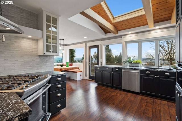 8014 SE Middle Way, Vancouver, WA 98664 - kitchen featuring stainless steel appliances, dark cabinetry, wall chimney range hood, backsplash, and wood ceiling
