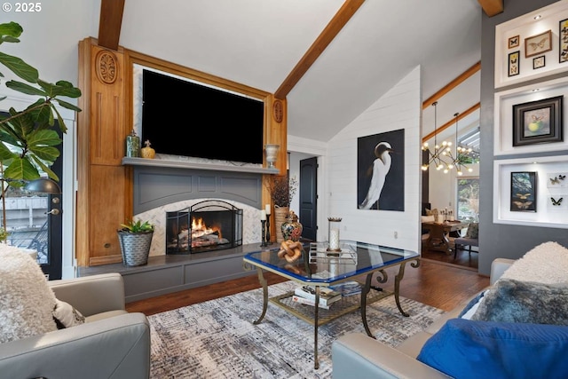 8014 SE Middle Way, Vancouver, WA 98664 - living room featuring a chandelier, wood finished floors, beamed ceiling, a lit fireplace, and high vaulted ceiling