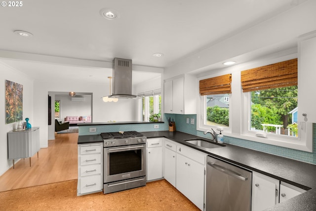 6945 SW 7th Ave, Portland, OR 97219 - kitchen featuring stainless steel appliances, island exhaust hood, dark countertops, white cabinetry, and recessed lighting