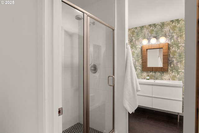 6945 SW 7th Ave, Portland, OR 97219 - full bath featuring wallpapered walls, vanity, a shower stall, and wood finished floors