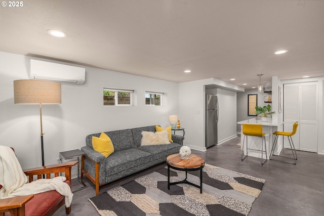 6945 SW 7th Ave, Portland, OR 97219 - living area with an AC wall unit, finished concrete flooring, and recessed lighting